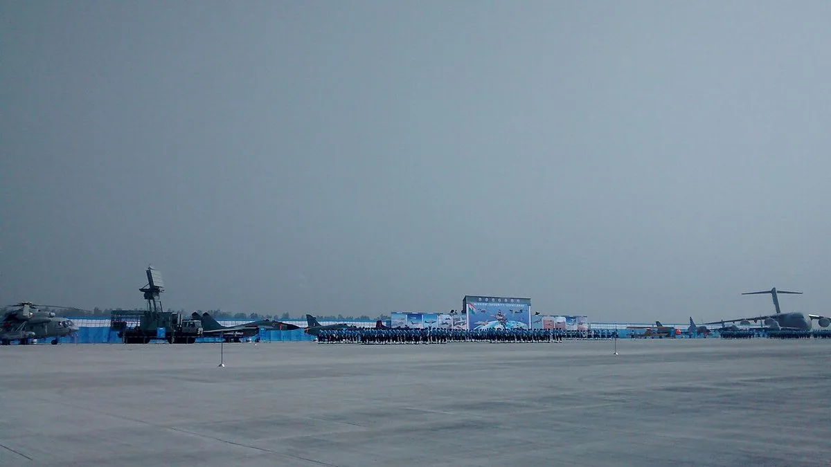 Indian Air Force personnel lined up on the tarmac with aircraft on display during the 2014 Air Force Day parade