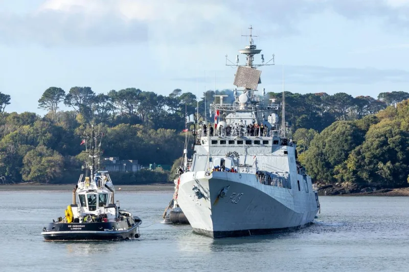 INS Trishul arriving at Plymouth, UK, escorted by a tug for Exercise Konkan-26