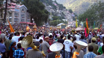 Crowds and deity palanquins fill the ground during the main procession of Kullu Dussehra in Himachal Pradesh