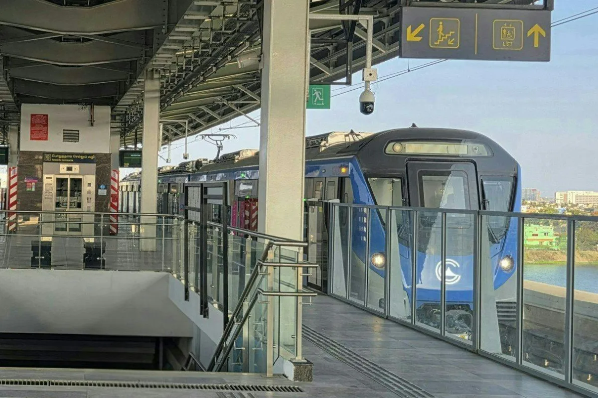 Blue Chennai Metro train arriving at the elevated Porur Bypass station